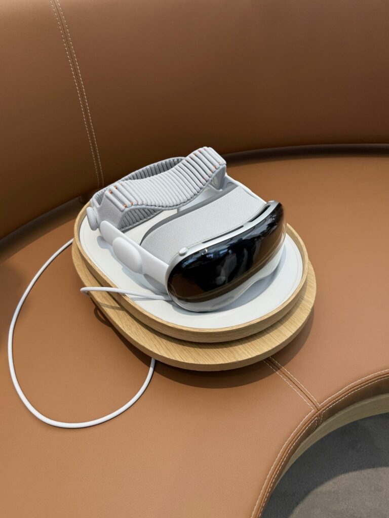 A sleek virtual reality headset rests on a charging stand with elegant leather seating.